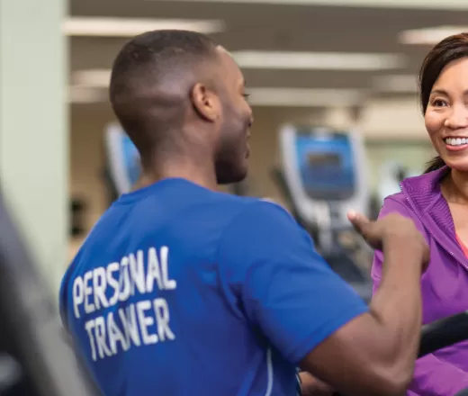 Personal Trainer with client on treadmill